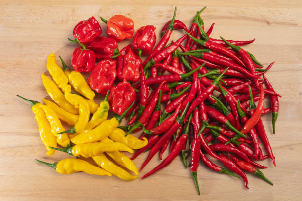 istock Bunch of assorted hot chili peppers on a wooden table 1024948488