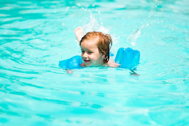 istock Cute boy swimming in the pool 1024953766