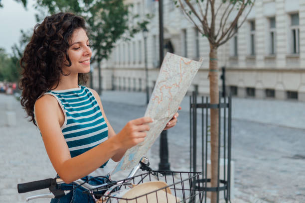 istock Beautiful woman cycling and reading a map 1024954420