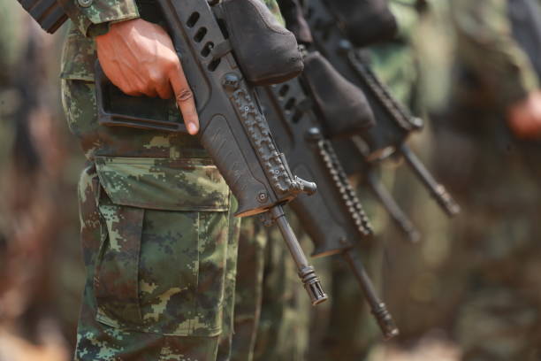 istock Midsection Of Army Soldiers Holding Rifles 1024954446