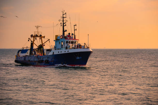 istock Sunrise and fishing boat 1024955230