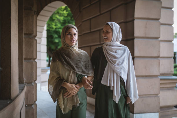 istock Beautiful Islamic women walking hand in hand and chatting 1024976476