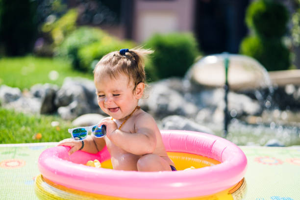 istock Cute toddler boy playing in inflatable pool 1024981136