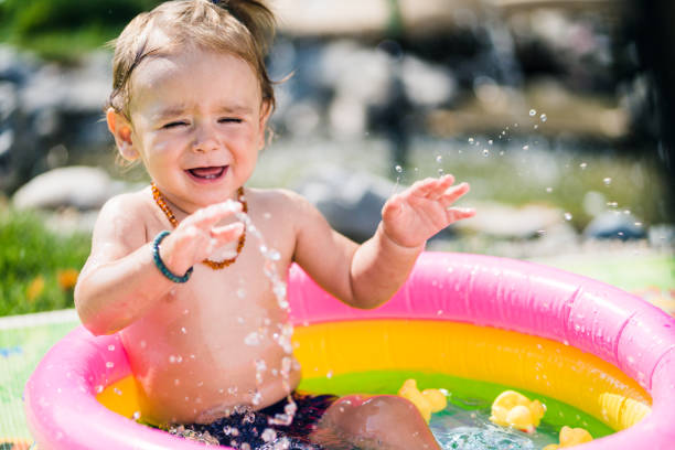 istock Cute toddler boy playing in inflatable pool 1024981206
