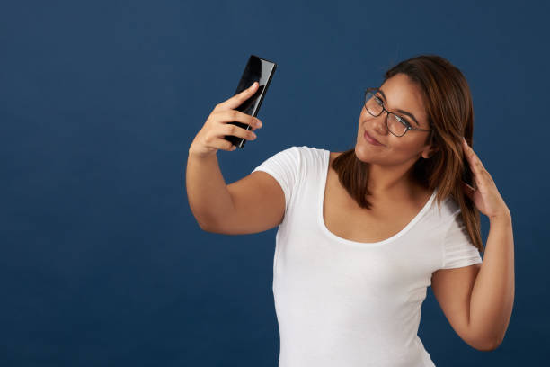 istock Girl in glasses take selfie 1024981558