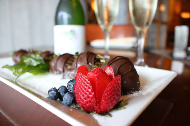 Chocolate Covered Strawberries and Champagne Sweet chocolate covered strawberries with sparkling wine chocolate covered strawberries stock pictures, royalty-free photos & images