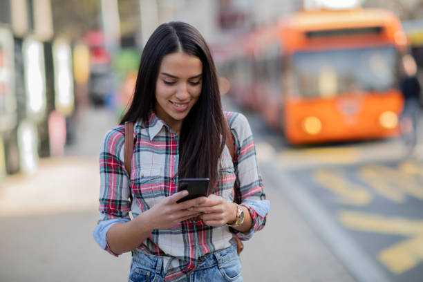 istock Girl texting on smartphone in the city 1024996308