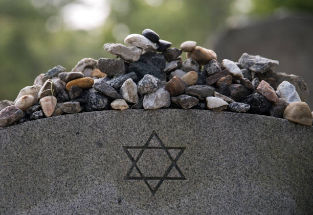 Stones on a Jewish grave. Remembrance stones left on a Jewish grave in Bonaventure Cemetery, Savannah Georgia. holocaust stock pictures, royalty-free photos & images
