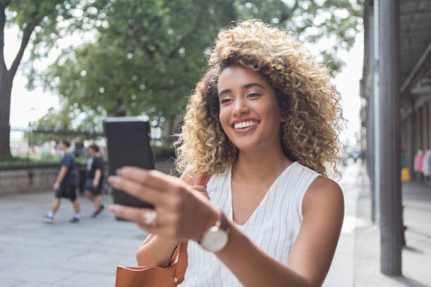 istock Young woman takes selfie while sightseeing 1025006244