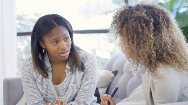 istock Distressed woman talking with counselor 1025006350
