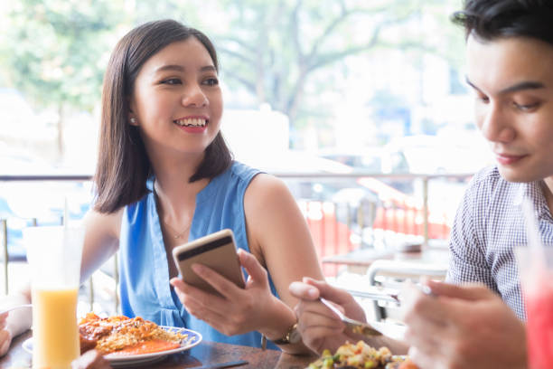 istock Young couple enjoy meal together 1025006456