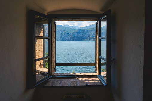 View of the Lake Garda through an old wooden framed window. Landscape format.