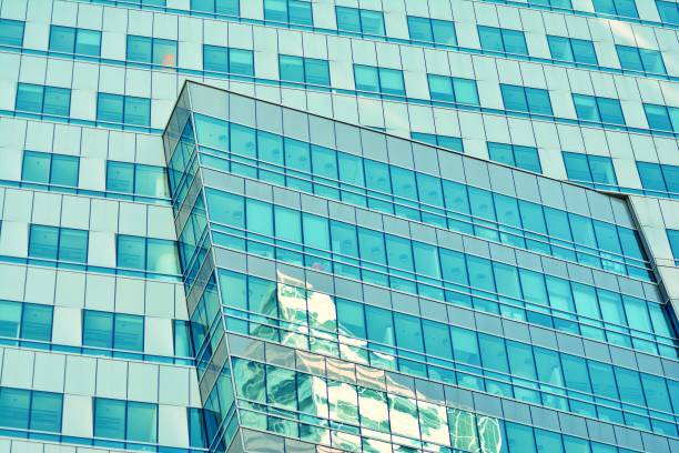 istock Modern office building on a clear sky background. Retro stylized colorful tonal filter effect 1025018798