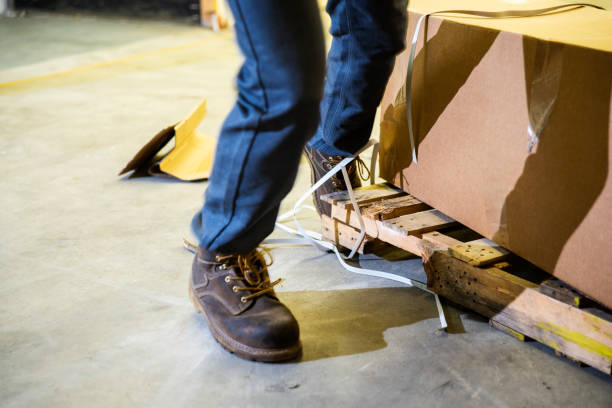 istock A worker in a warehouse tripping over a broken pallet 1025024306