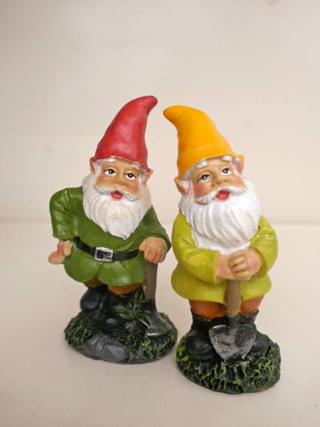 istock Two garden gnomes in front of a neutral background 1025036200