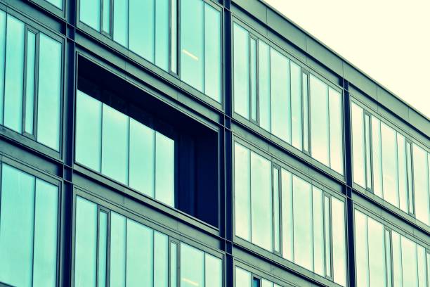 istock Modern office building on a clear sky background. Retro stylized colorful tonal filter effect 1025036370