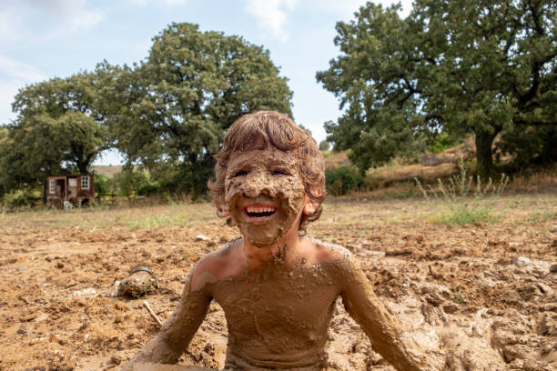 istock Little boy playing in mud 1025036750