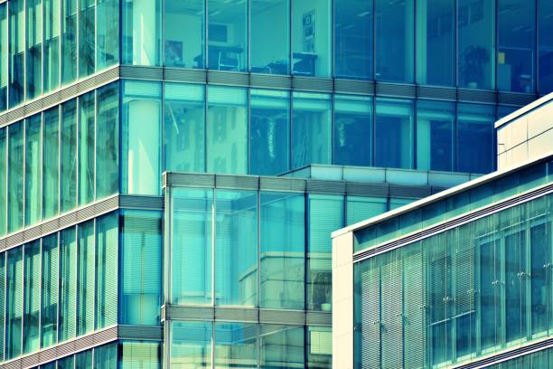 istock Modern office building on a clear sky background. Retro stylized colorful tonal filter effect 1025036872