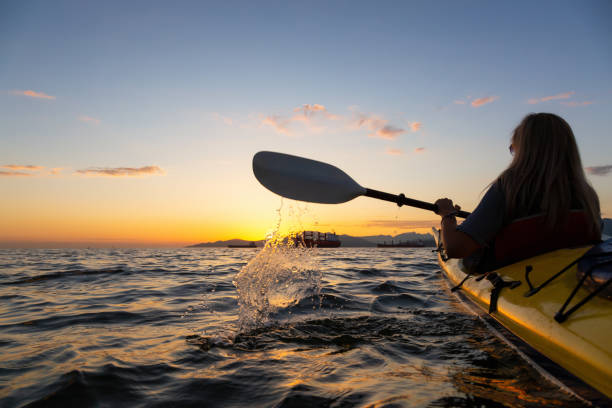 istock Girl Sea Kayaking during Sunset 1025055092