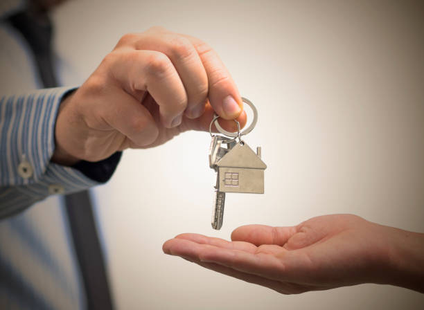istock man holding a home key in his hand 1025062720