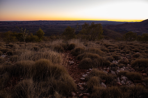 The beautiful afternoon light as the sun sets over the West Macdonell Ranges out of Alice Springs Northern territory. This view as seen from Hill Top between Finke River Camp and Rocky Bar Gap.