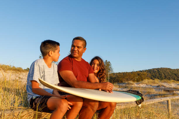 Australian Aboriginal Father and Children Australian Aboriginal Father and children at the beach in the early morning australian aborigine culture stock pictures, royalty-free photos & images