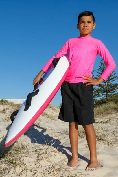 australian aboriginal boy at beach with surf rescue board - gold coast australia lifeguard sea imagens e fotografias de stock