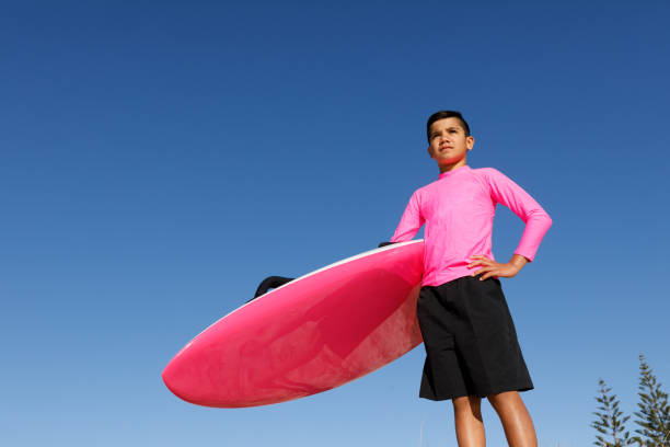 australian aboriginal boy at beach with surf rescue board - gold coast australia lifeguard sea imagens e fotografias de stock