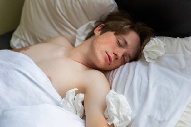 istock Sick Teenager Sleeping In Bed 1025098634