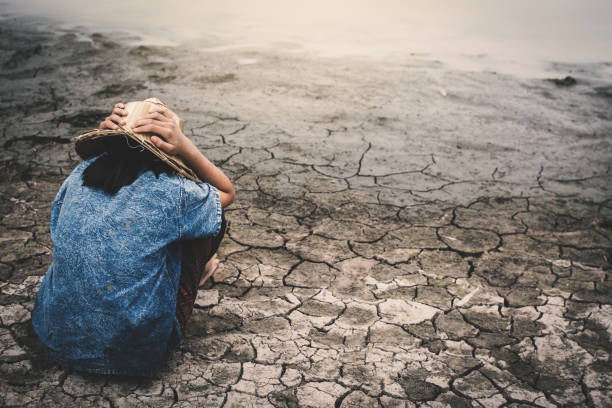 istock Girl Wearing Hat While Sitting On Ground 1025103306