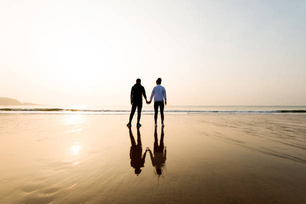 istock Couple holding hands at beach 1025103524
