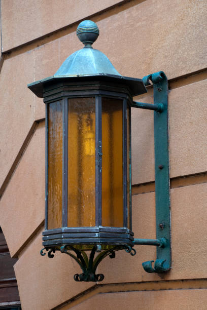 istock Old fashion lantern attached to sandstone wall 1025112050