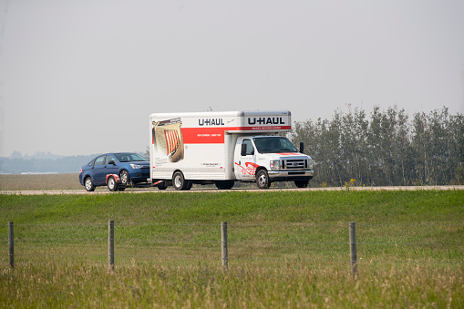 A u haul truck carrying cargo down a highway. Taken near Red Deer, Alberta, August 10, 2018