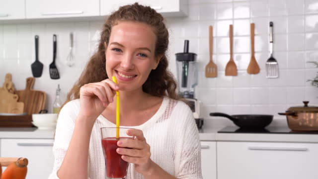 Young woman drinking Beetroot Juice