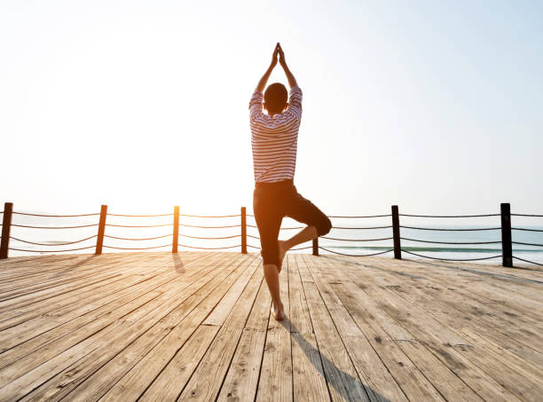 istock Man doing yoga at the seaside 1025158096