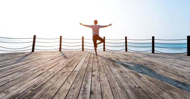 istock Man doing yoga at the seaside 1025158354