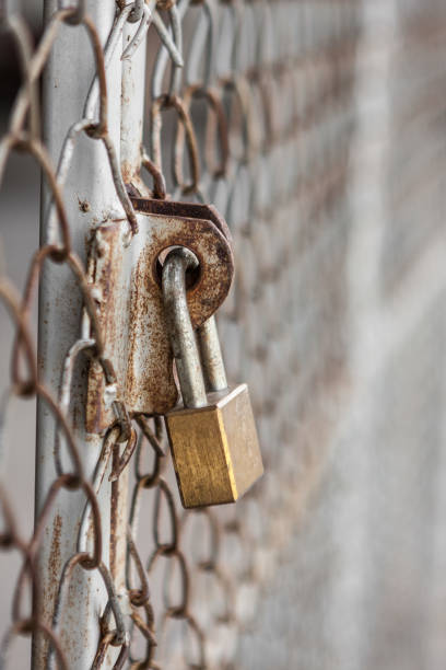 istock Padlock and fence grill rust texture background 1025158696