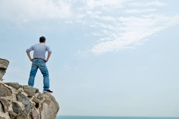 istock Man standing on the cliff by sea 1025159108