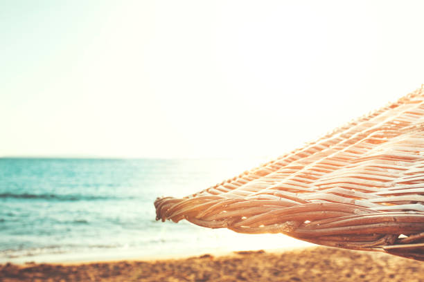 Two reclining chairs on the beach at sunrise