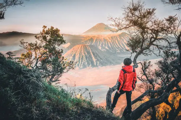Traveler Man and sunrise at volcano Mt.Bromo (Gunung Bromo) Kingkong hill East Java,Indonesia