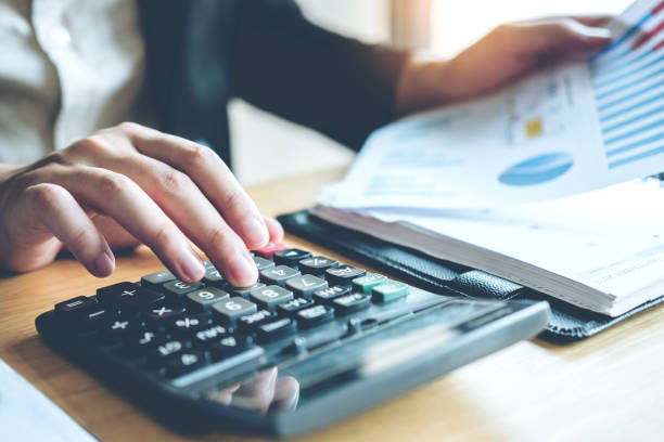 istock Business man Accounting Calculating Cost Economic 1025175528
