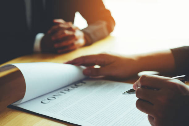 istock Business people negotiating a contract between two colleagues 1025175532