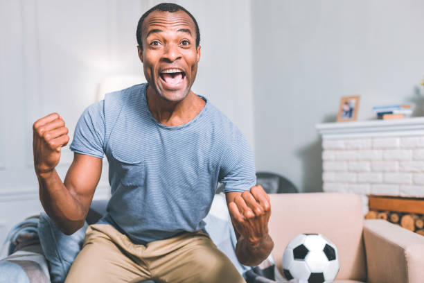 istock Obsessed football fan watching a match 1025180410