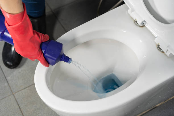 istock hand cleaning toilet bowl with a detergent 1025182954