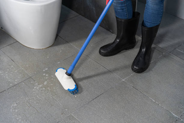 istock hand using brush to cleaning the tile in bathroom 1025182958