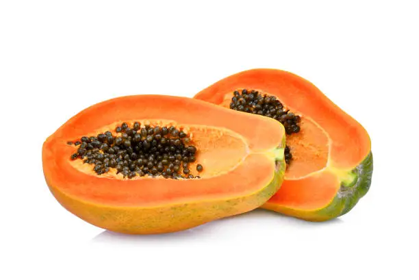 two half cut of ripe papaya with seeds isolated on white background