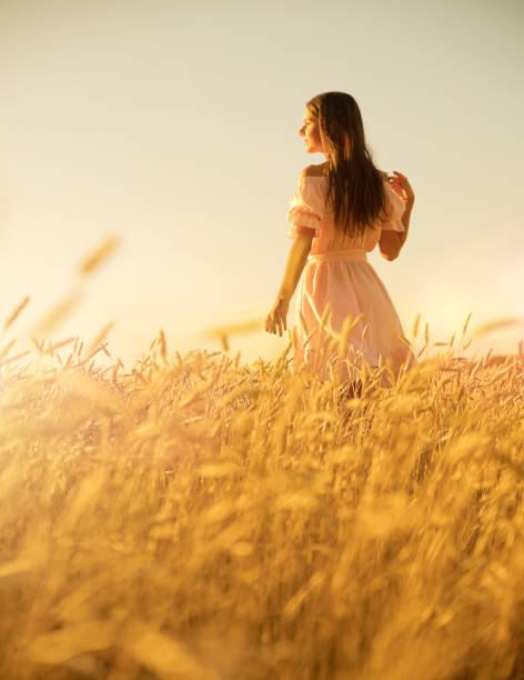 istock Woman in wheat field at sunset 1025190220