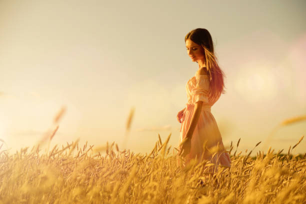 istock Woman in wheat field at sunset 1025190246
