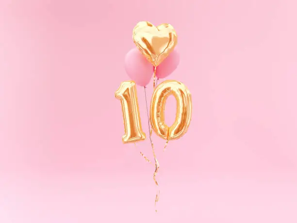 Photo of 10 years old. Gold balloons number 10th anniversary