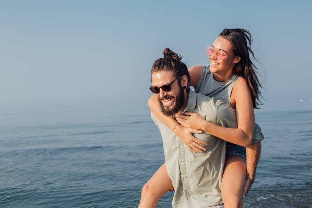 istock Young couple having a great time at beach 1025207236
